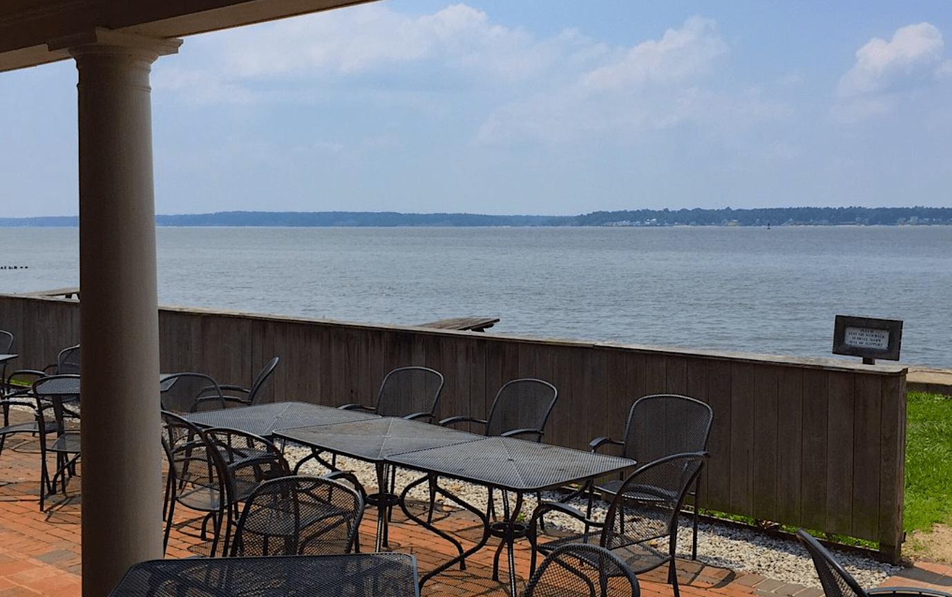 Outdoor seating at Dale House Cafe at Historic Jamestowne overlooking the waterfront of the river. 